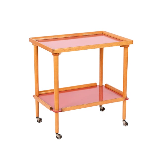 Fantastic midcentury serving trolley in beech wood with two formica red shelves. This unique piece was produced in Italy...