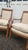 Handsome pair of vintage French Empire style armchairs featuring warm walnut-toned wood frames, square upholstered backs,...