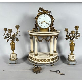 Louis XVI style mantel clock and floral candelabra. For Sale