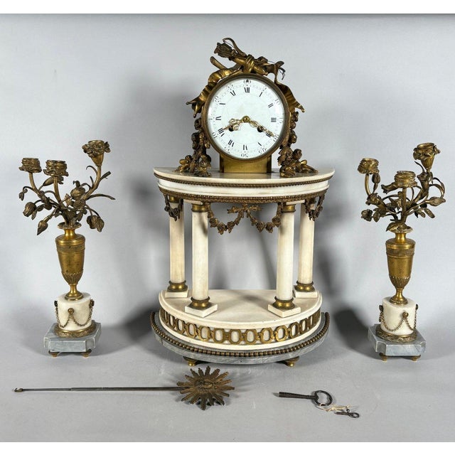 Louis XVI style mantel clock and floral candelabra. For Sale