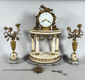 Louis XVI style mantel clock and floral candelabra.