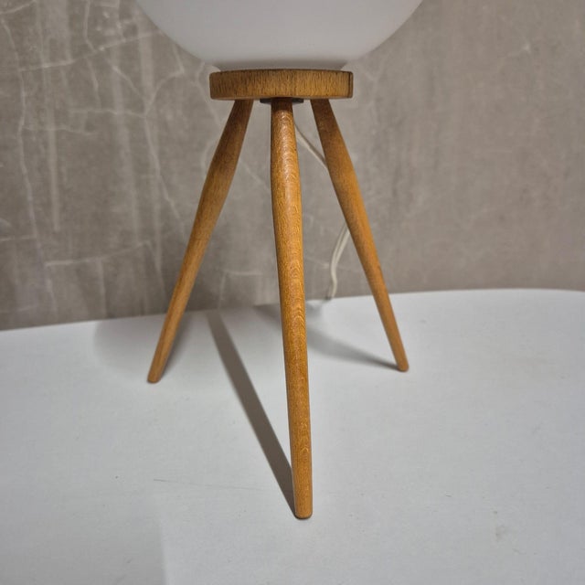 This mid-century tripod table lamp was produced by úľuv in czechoslovakia during the 1960s. It features a distinctive...
