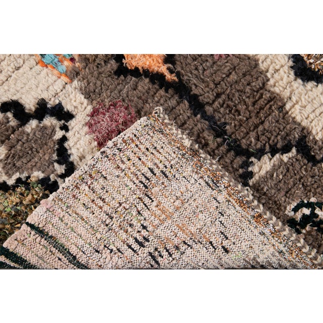 Beautiful Vintage American Rag hand knotted wool rug with a multi-color field. This piece has geometric tribal design....