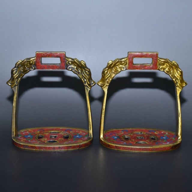 This is a matched pair of antique cloisonné enamel stirrups, traditionally used for horseback riding and often collected...