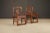 A refined pair of Chinese armchairs, crafted in solid elmwood and likely dating to the Qing Dynasty period (1644–1912),...
