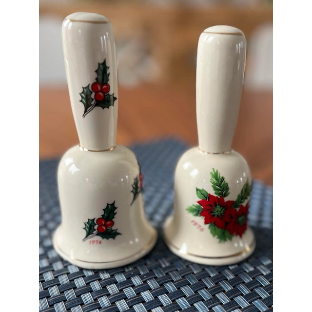 Sweet, hand-painted, porcelain bells decorated in poinsettias and holly. Perfect accents for your holiday season. Dated...