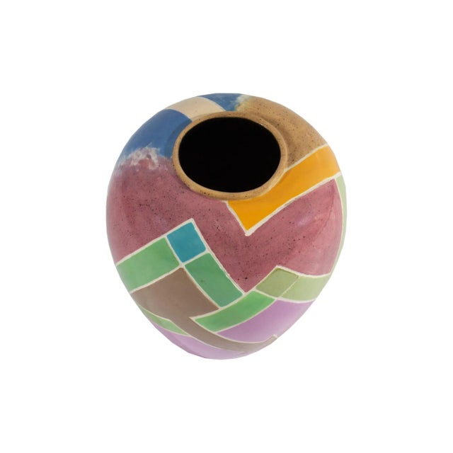 A 1988 ceramic vase by the American artist Doris Vlasek-Hails (1938-2004). This colorful Postmodern vase features a...