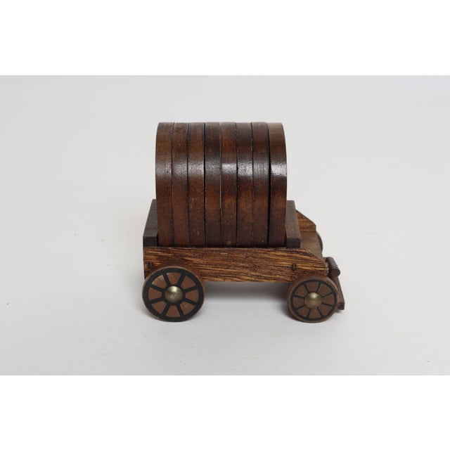 Western-style wooden coaster souvenir set including eight coasters with horse imagery on inset cork housed within a wagon...