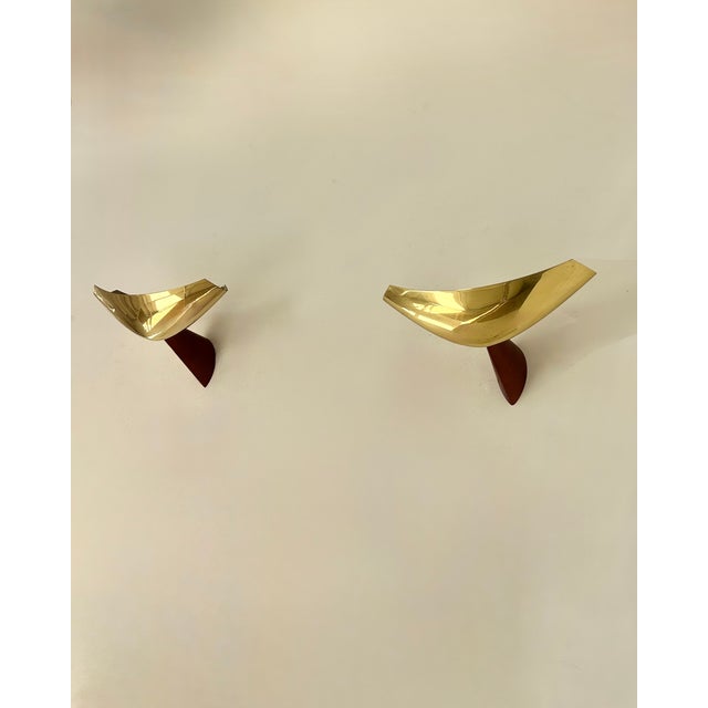 Pair of wall sconces composed of an exotic wood frame and a brass diffuser, produced by Arteluce in Italy in the 1980s and...