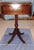 This authentic Duncan Phyfe style mahogany drop-leaf pedestal side table was manufactured by the renowned Brandt Furniture...