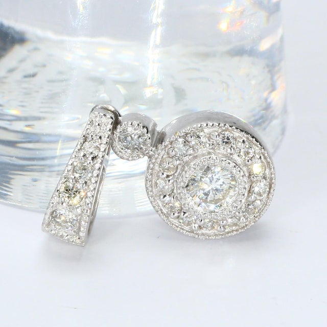 This is an 18k white gold pendant with a round white diamond. - Stone Info - 1x Round-cut, white diamond Total Weight - 1.66g