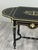 A superb Napoleon III style coffee table in black lacquered wood, richly decorated with gilt lines and motifs in the...