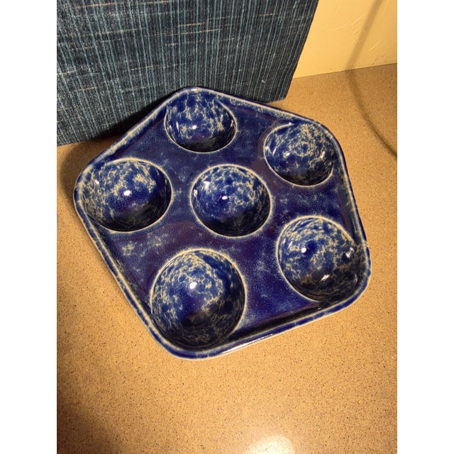 Bennington Pottery blue agateware escsrgot dishes with six holes each.