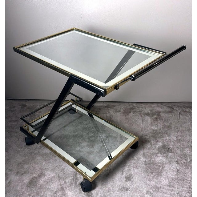 Elegant Italian bar cart from the 1960s, crafted in a refined combination of burnished steel and polished brass,...