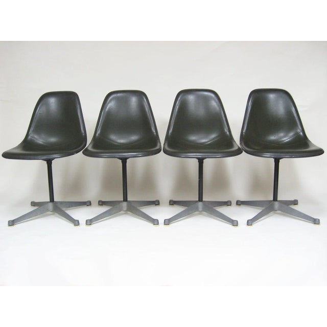This set of side chairs by Charles and Ray Eames are post-war classics. The seats are elephant hide gray fiberglass with...