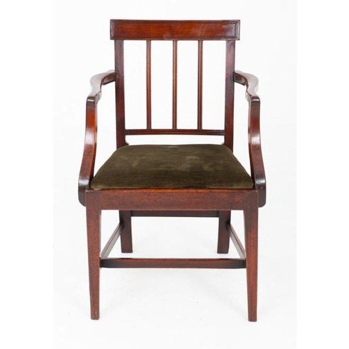 A fine Georgian mahogany armchair of elegant and restrained form. Raised upon tapered legs united by an H-frame stretcher....