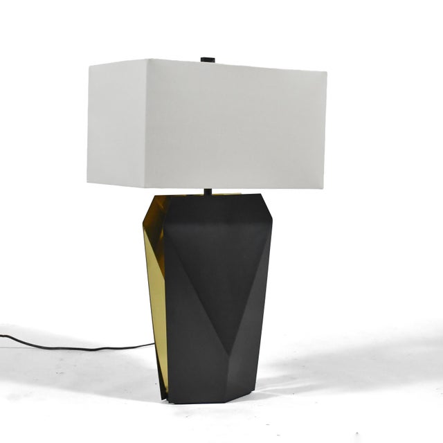 The "Origami Temko" lamp by Donghia is an homage to Florence Temko, a master origami artist. It features a base of brass...