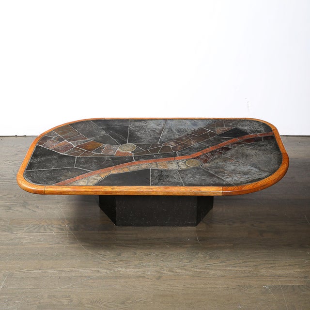 This bold and materially unique Mid-Century Modernist Tessellated Slate and Bronze Inlay Cocktail Table signed V Ramburrem...