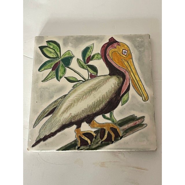 Beautiful colourful polychrome Handpainted Pelican figurine, signed verso ceramic tile : trivet. Collectible