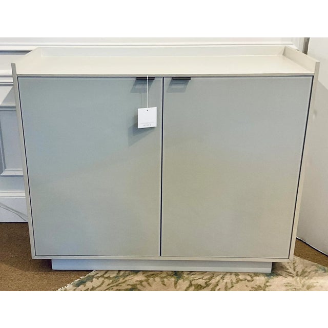 Stylish Caracole Contemporary Gray and Beige Glass Door Chest, one drawer three shelves, showroom floor sample