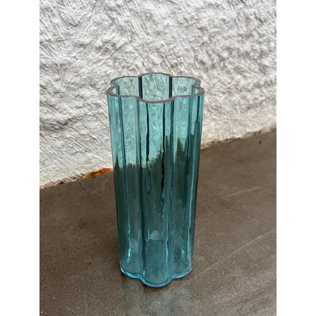 Blue glass scalloped sides glass vase design by Jens Quistgaard for Dansk. The vase is not marked.