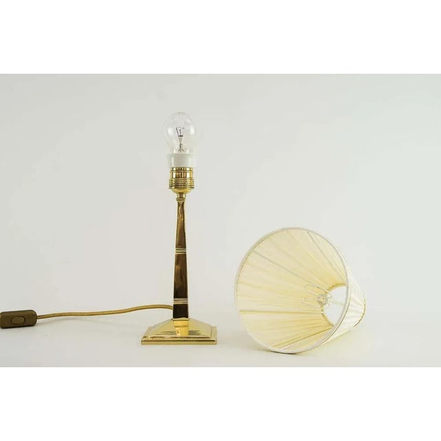 Art Deco table lamp from Vienna from around 1920s with fabric shade. Polished and stove enameled. European Plug (up to...