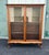 A beautiful antique bookcase made of solid cherry in a Queen Anne style. Features two swinging glass doors, behind which...