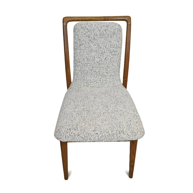 Midcentury inspired smooth wood frame dining chair with light grey and cream upholstered seat and floating back. Each...