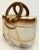 Beach bag shaped ceramic cookie jar with lid. Both front and back of cookie jar have identical raised and painted details...