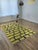 One-of-a-kind handwoven Moroccan rug. A saturated chartreuse ground divided into a brick-like grid by black and white...