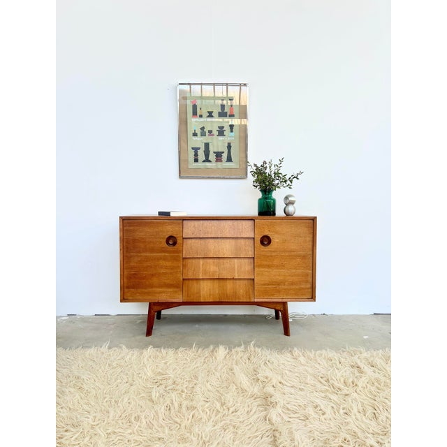 A teak sideboard with a strong character: round handles carved in relief into the wood, almost brutalist—a far cry from...