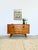 A teak sideboard with a strong character: round handles carved in relief into the wood, almost brutalist—a far cry from...