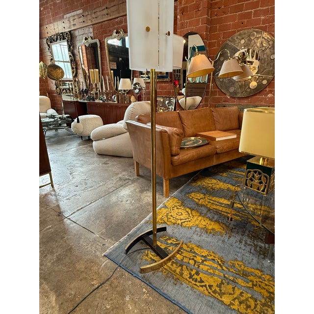 Arredoluce Floor Lamp Model "12707" by Angelo Lelii, Italy, 1950s. This elegant brass and glass floor lamp features a...