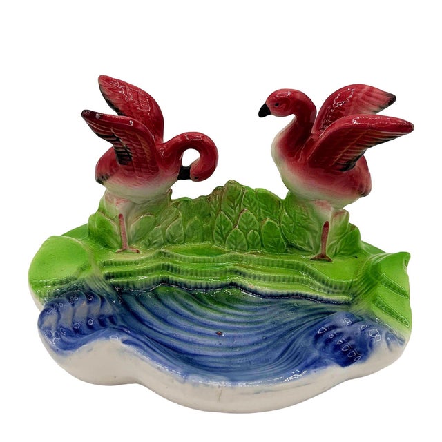Mid-century Era hand-painted pink and green ceramic ashtray with a flamingo couple. The ashtray features a beautifully...