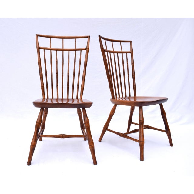 A pair of Nichols & Stone Birdcage Windsor dining chairs featuring split wedge mortise and tenon joinery with faux bamboo...