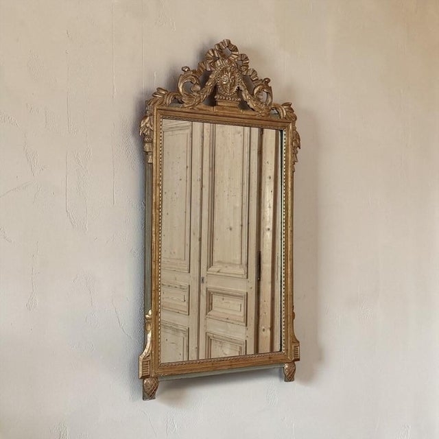 Graceful ribbons, delicate floral garlands, and beautifully aged gilding give this 19th century Italian Louis XVI carved...