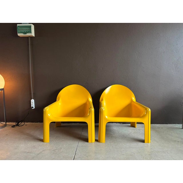 Pair of iconic model 4794 lounge chairs designed by Gae Aulenti, in bright yellow, and manufactured by Kartell/Italy, in...