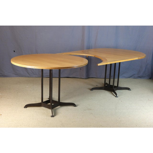 Pair of round tables with a modular system that can be joined to form one large table. The tabletops are made of light oak...