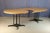 Pair of round tables with a modular system that can be joined to form one large table. The tabletops are made of light oak...