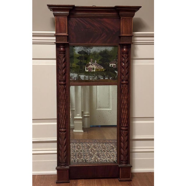 Handsome carved walnut federal mirror. Crotch walnut veneer panel below stately stacked cornice. Beautifully carved...