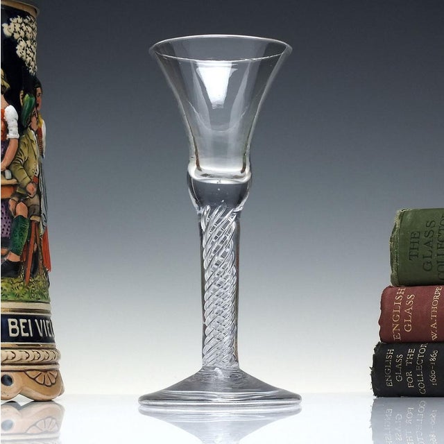 A fine 18th-century air twist wine glass dating to c1745. It has a large bell bowl with a solid section at the base. Sits...