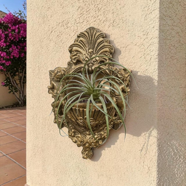 A substantial Italian gilt chalkware wall pocket dating to 1978, modelled in an exuberant Baroque Revival vocabulary with...