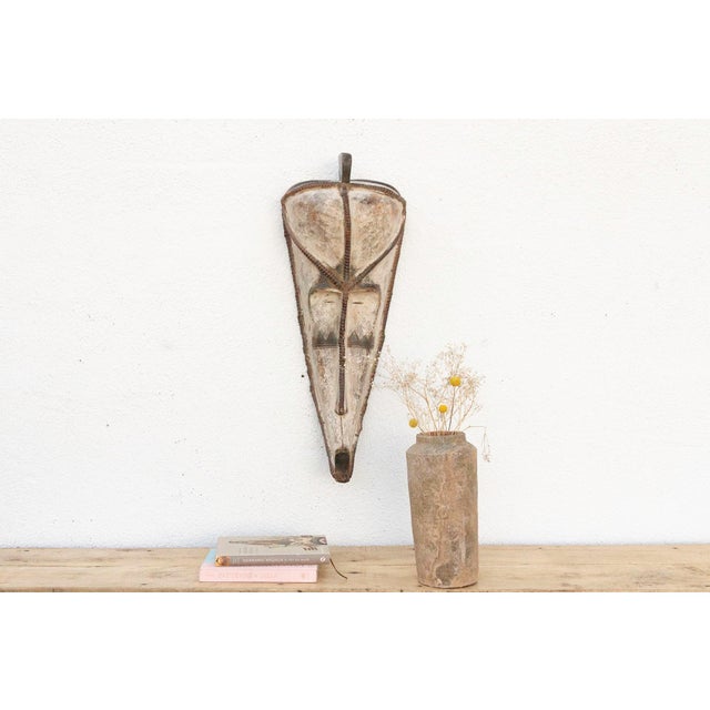 An authentic Fang Ngil mask, standing at an impressive 31 inches high and approximately 12 inches wide. Originating from...