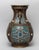 The vase exterior is cast with flower scrolls on turquoise ground, set with raised vertical bands and two handles, the...