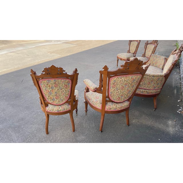 Exceptional antique 19th-century Victorian Renaissance Revival carved walnut parlor set. Includes a setee one arm chair...