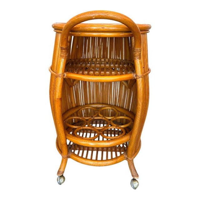 Italian mid-century bar cart crafted from warm-toned rattan and bamboo in a distinctive barrel form. This beautifully...