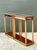 This sophisticated pair of side tables expertly blends Neoclassical elegance with French Directoire-style influences....