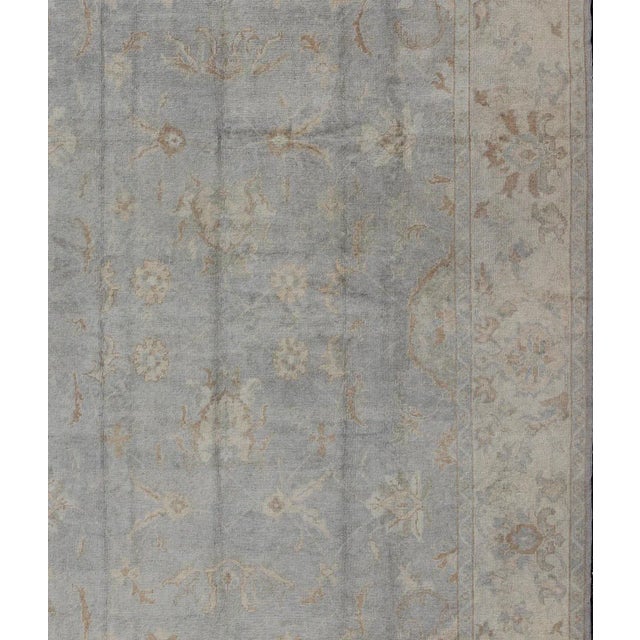 Large Turkish Oushak Rug Large Turkish Oushak rug with all-over vining floral design in pale blue, light brown and cream,...