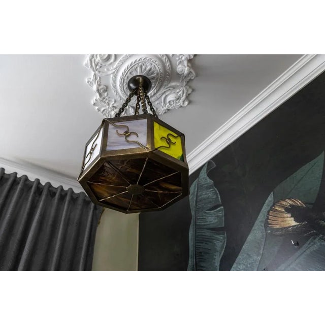 Midcentury octagonal metal and polychrome tiffany glass pendant light, germany, 1950s. this striking mid-century pendant...