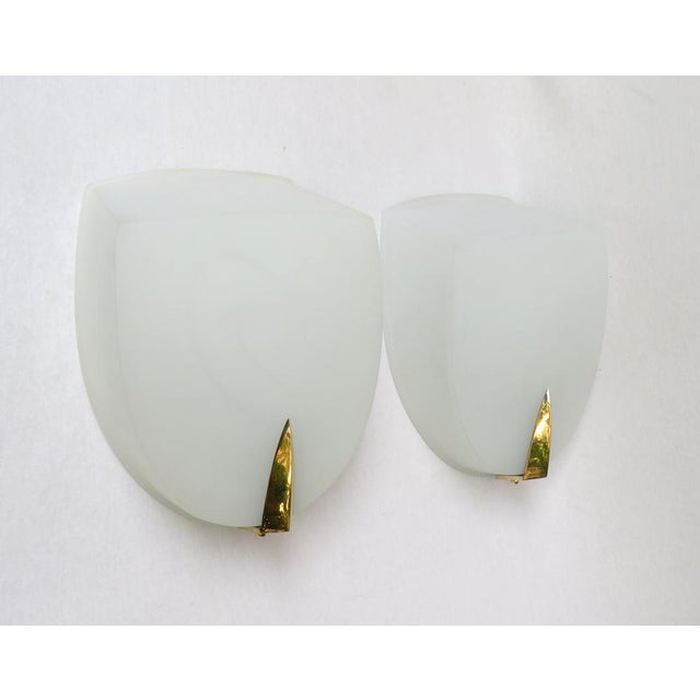 An extraordinary and elegant set of 4 large wall lights, made in France in the 1950s in a minimalist design. The lights...